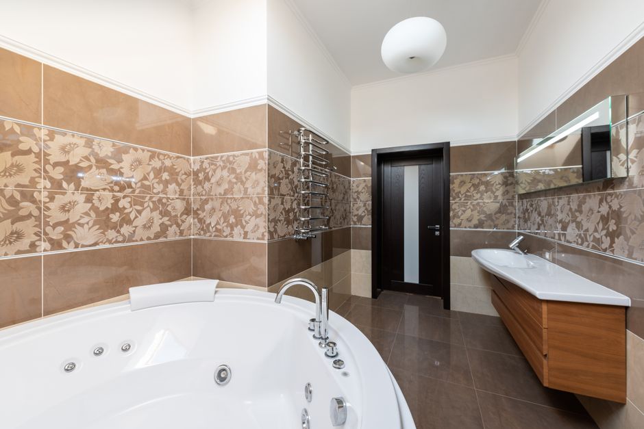 Clean modern residential bathroom with a wall-mounted toilet and neutral tile